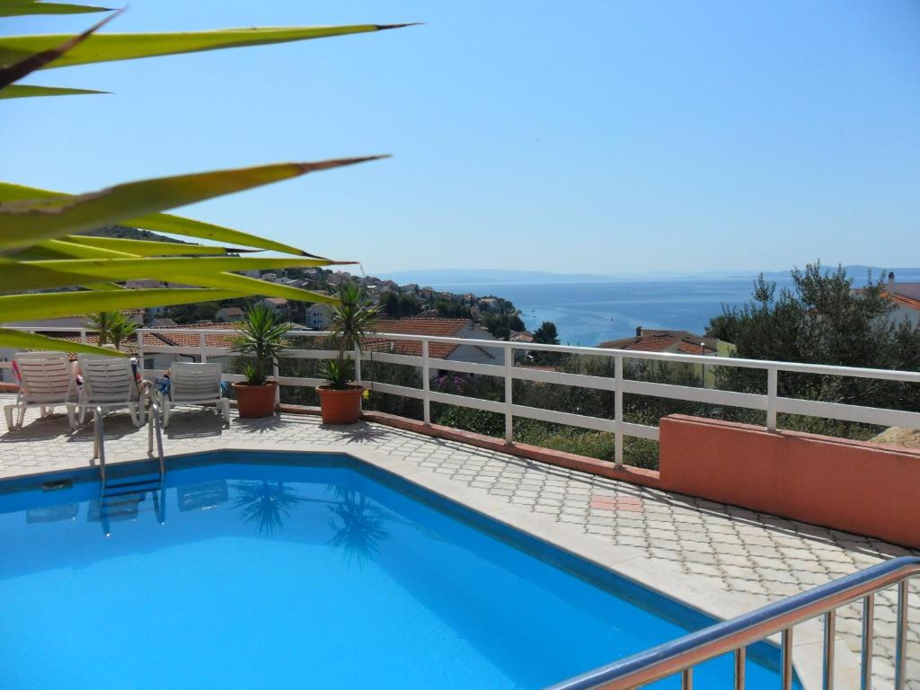 a swimming pool on the balcony of a house at Apartments Mavarcica in Trogir