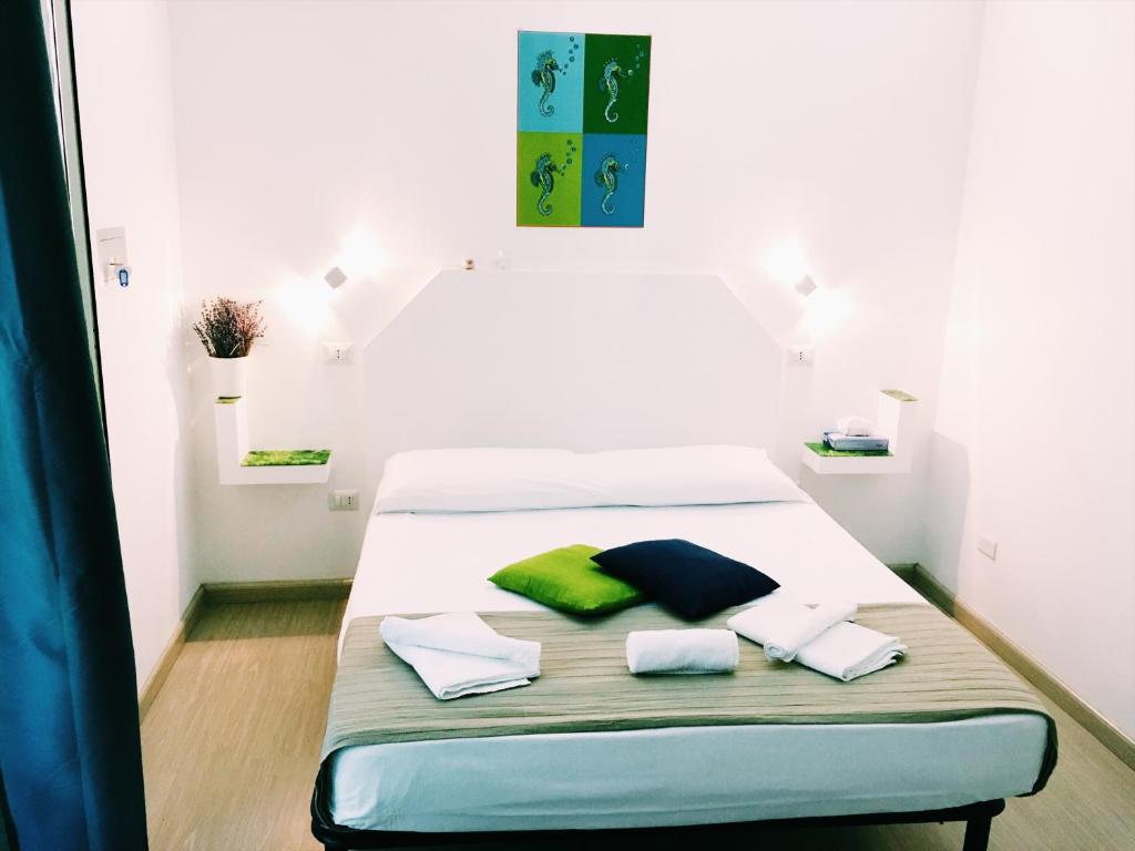 a bed in a room with two pillows on it at Enjoy Tropea Accomodation in Tropea