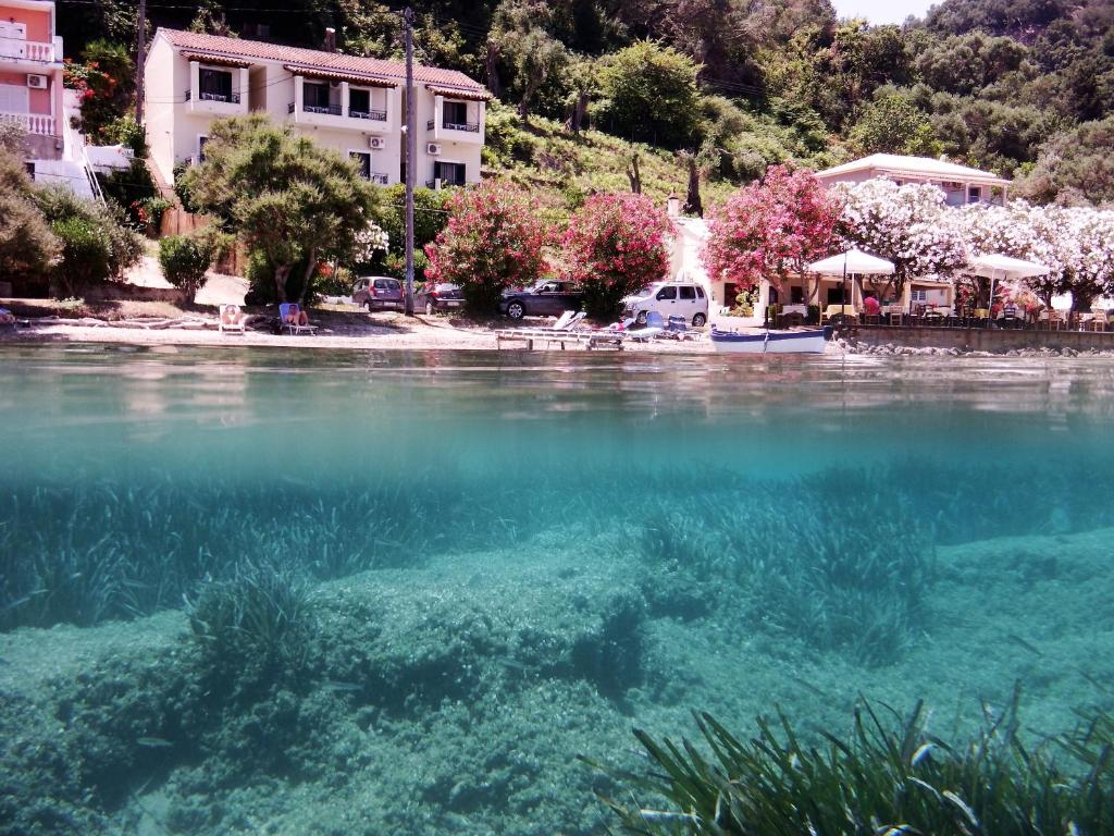 a view of a body of water with buildings at Akrogiali Rooms in Boukari