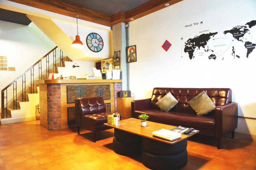 a living room with a couch and a table at Knock Knock Hostel in Kaohsiung