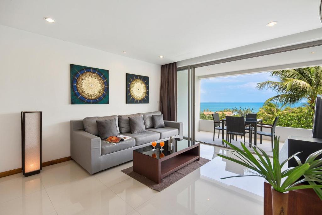 a living room with a couch and a table at Tranquil Residence 1 - Luxury Apartment in Lamai