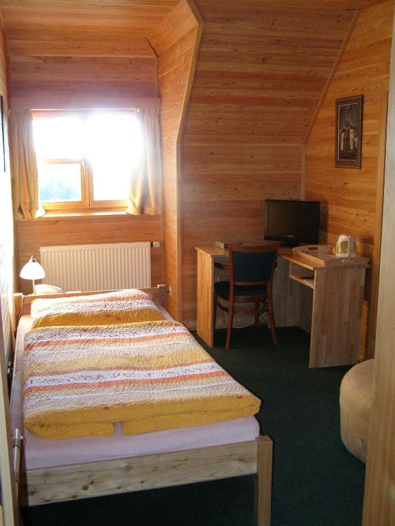 Postel nebo postele na pokoji v ubytování Lesní penzion Bunč
