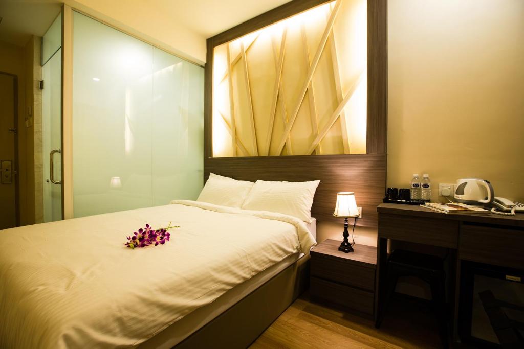 Postel nebo postele na pokoji v ubytování Hotel CIQ @ Wong Ah Fook