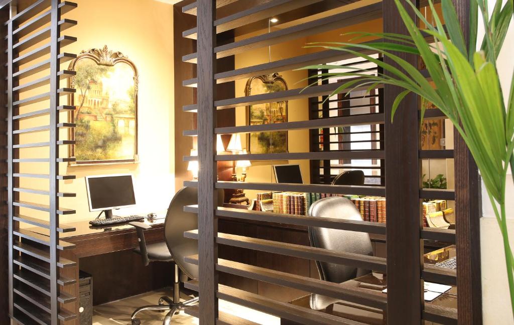 an office with a desk and a chair and a computer at The Eclipse Boutique Suites in Abu Dhabi