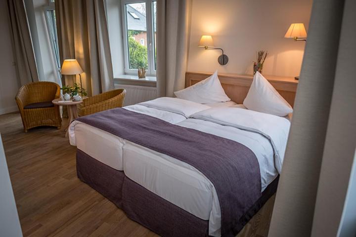 a bedroom with a large bed in a room at BE BIO Hotel be active in Tönning