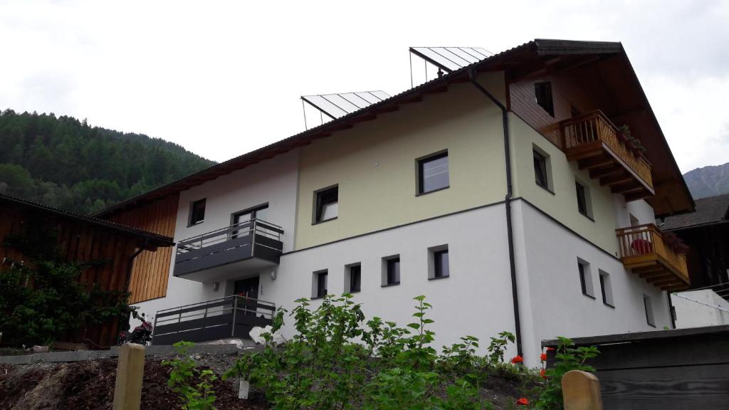 a white building with balconies on the side of it at Haus Heidrun in Fendels