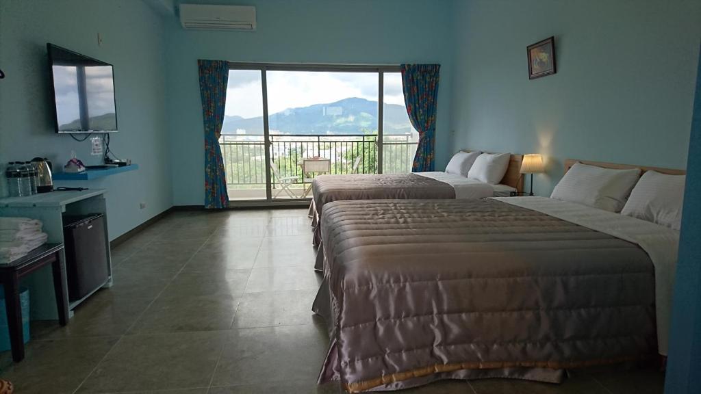 Postel nebo postele na pokoji v ubytování Kuan Min B&B