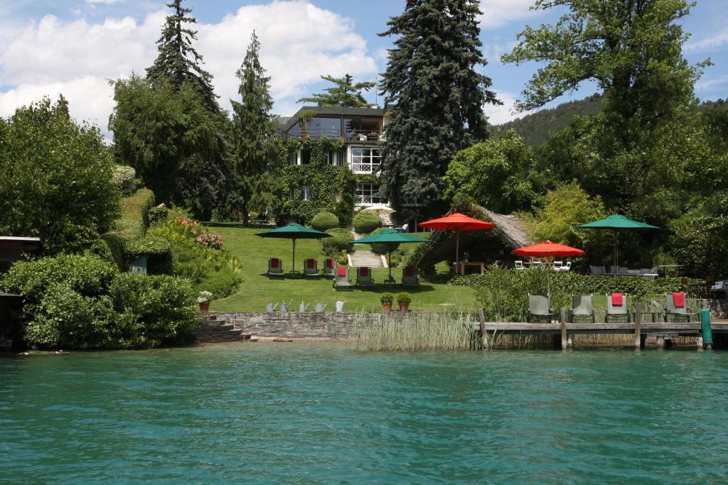 a view of a house from the water at Villa Christa in Velden am Wörthersee