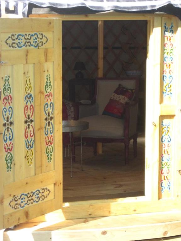 a wooden room with a chair and a window at Le Mas Nomade in Callian