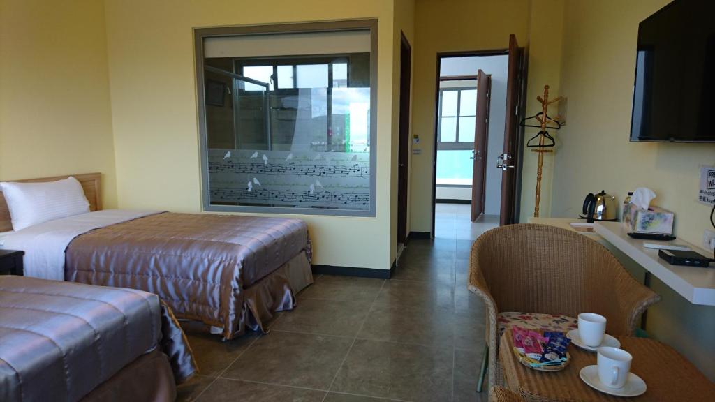 Postel nebo postele na pokoji v ubytování Kuan Min B&B