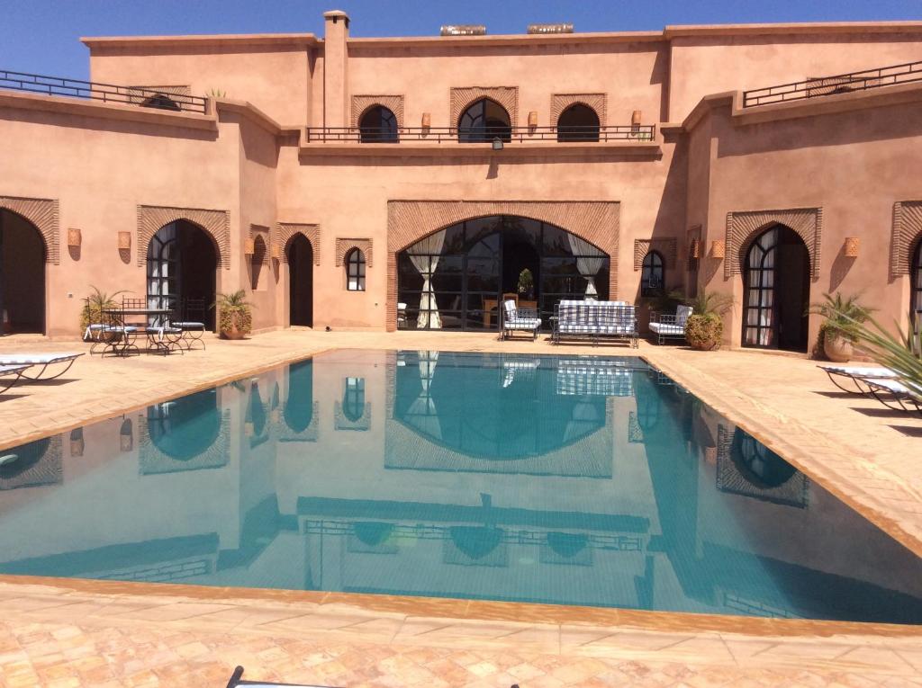 a swimming pool in the middle of a house at Villa TYCOZ in Marrakesh