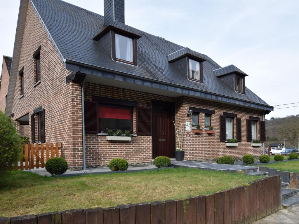 a brick house with a black roof at Cozy Family Holiday Home in La Roche-en-Ardenne