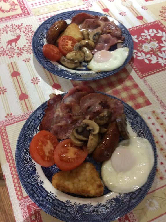 two blue plates of food on a table at Poplar Farm in Wedmore