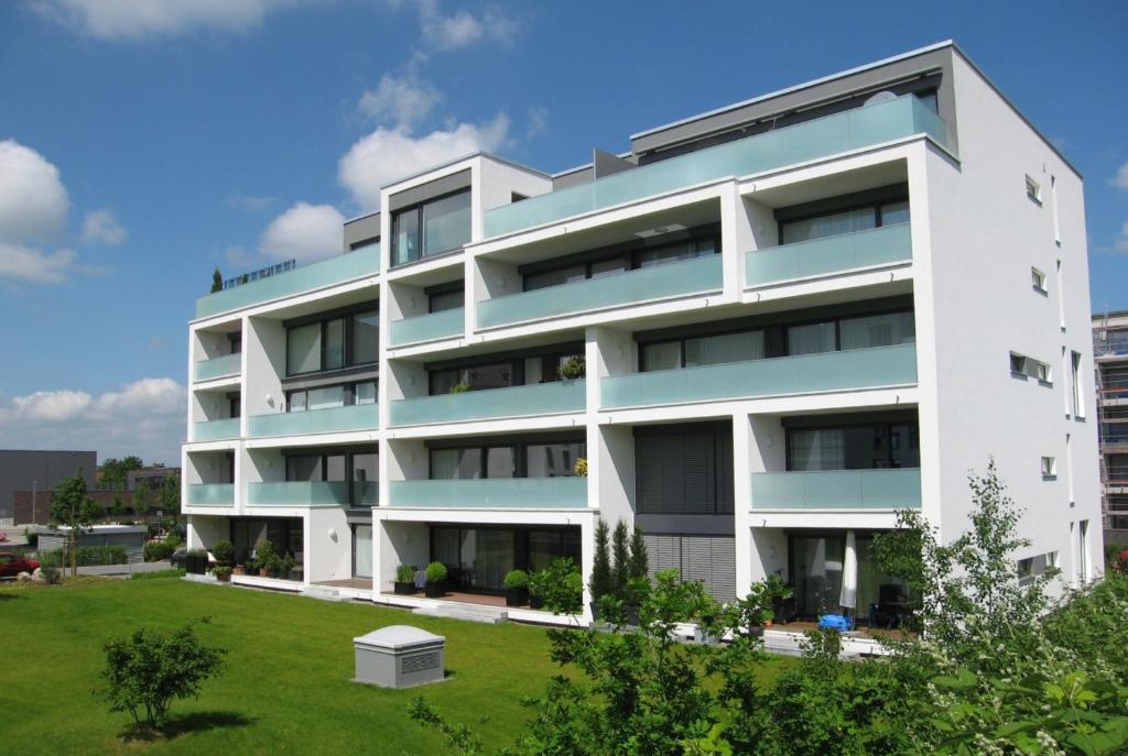 an apartment building with a lawn in front of it at Fewo Speicherquartier in Lüneburg