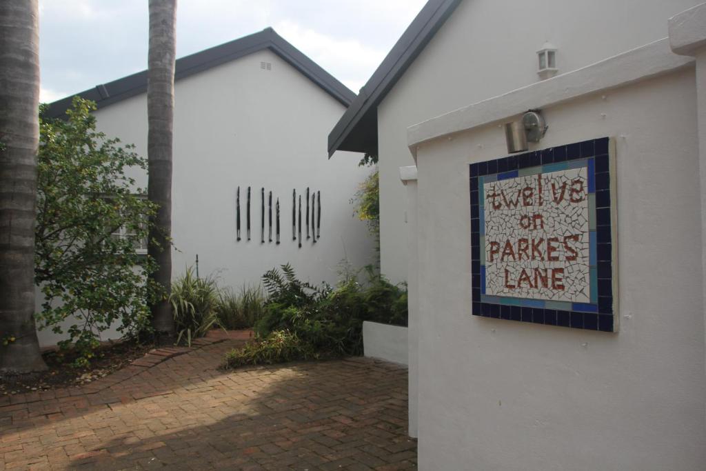 a sign on the side of a building with a house at 12onParkesLane in Knysna