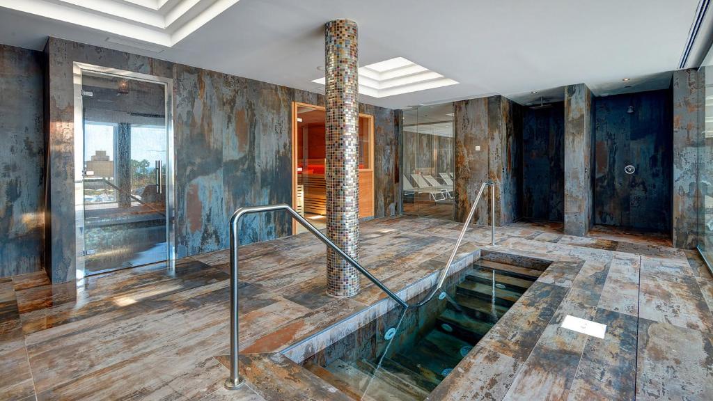 a room with a swimming pool in the middle of a building at Hipotels Playa de Palma Palace&Spa in Playa de Palma