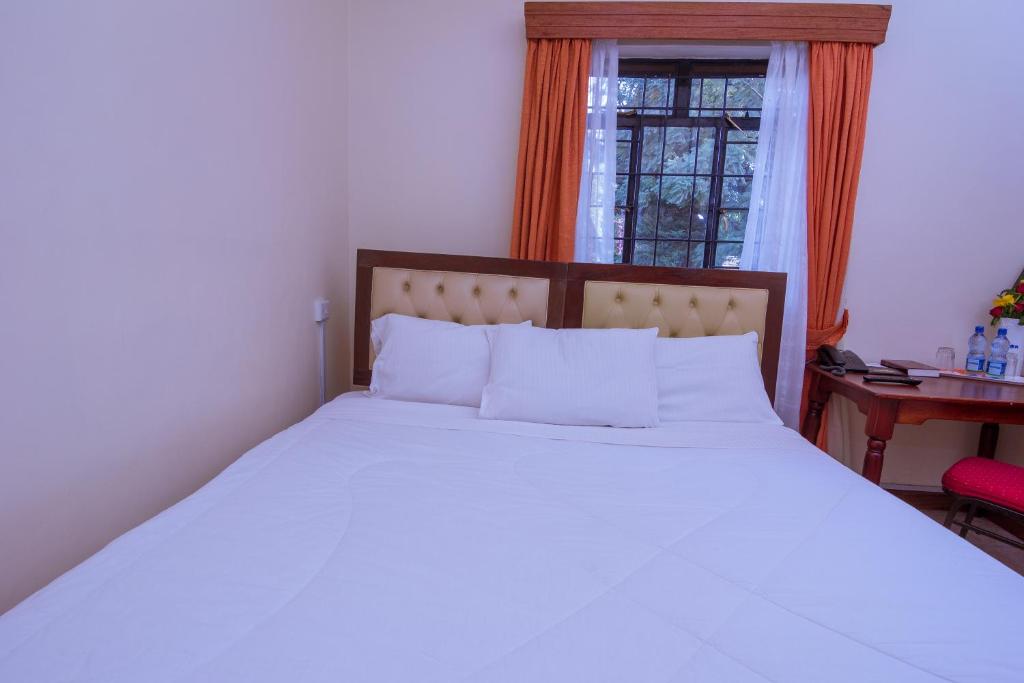 Postel nebo postele na pokoji v ubytování Chak Guesthouse & Conference Center