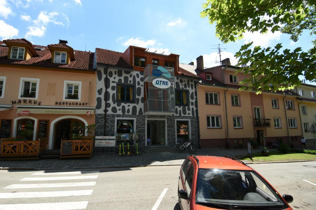 a red car parked in front of a building at Apartments Otre Frymburk in Frymburk