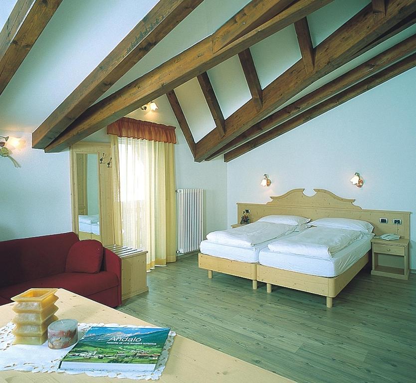 Postel nebo postele na pokoji v ubytování Hotel Rosa Alpina