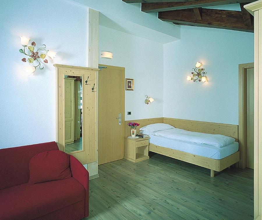 Postel nebo postele na pokoji v ubytování Hotel Rosa Alpina