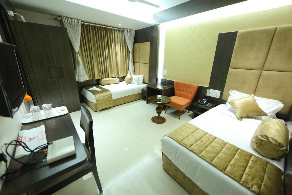 Postel nebo postele na pokoji v ubytování Hotel President