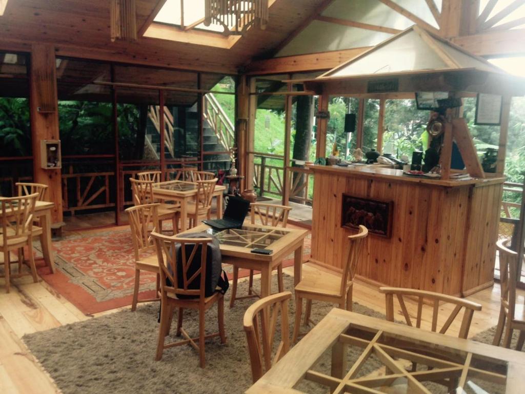 a pavilion with a table and chairs and a stove at King Fern Cottage in Nuwara Eliya