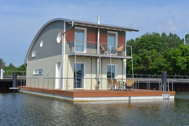 a house on a boat in the water at Ruegen in Wiek auf Rügen