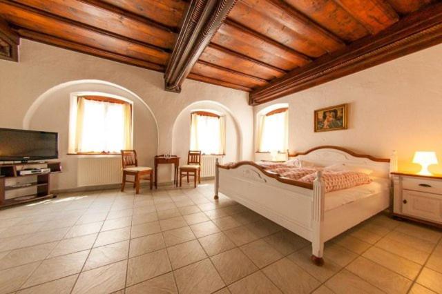 a bedroom with a bed and a flat screen tv at Pension U Zámku in Český Krumlov