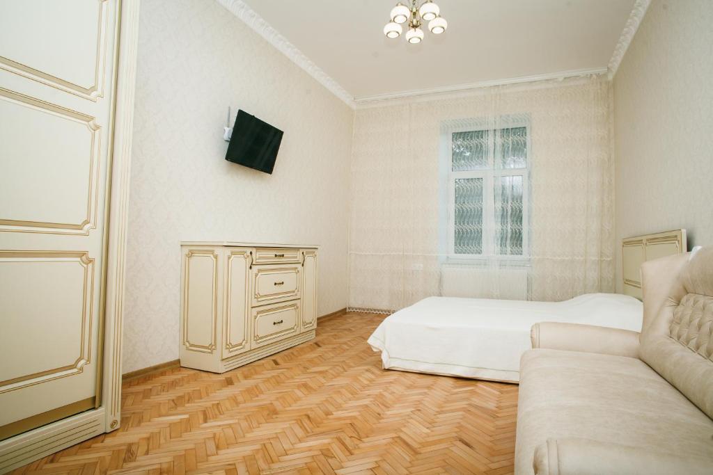 リヴィウにあるApartment on Stefanyka 11の白い部屋(ベッド1台、ソファ付)