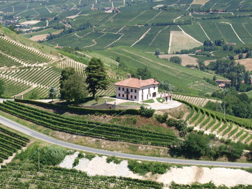 ein Haus auf einem Hügel neben einer Straße in der Unterkunft Villa Bricco Paglieri, entire Villa in Alba