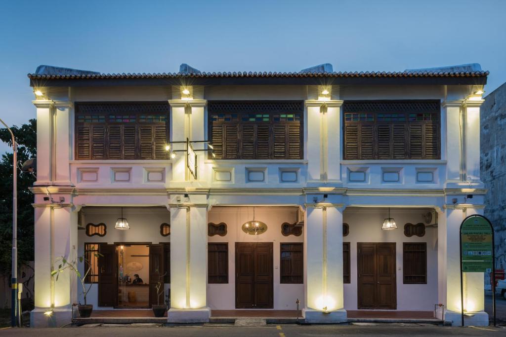 Un grand bâtiment blanc avec des lumières sur lui dans l'établissement Rope Walk Guest House, à George Town