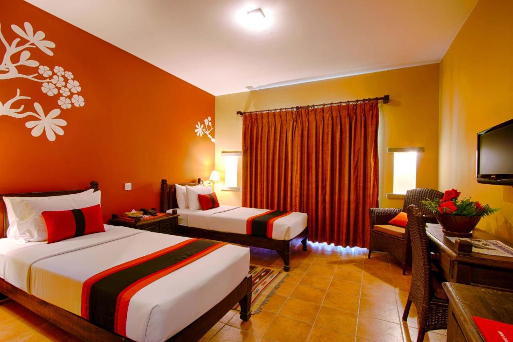 Llit o llits en una habitació de Temple Tree Resort & Spa