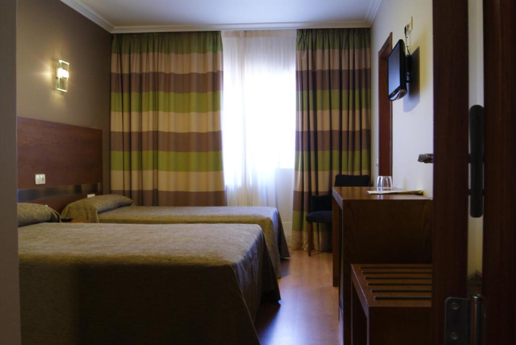 Postel nebo postele na pokoji v ubytování Hotel Puente de La Toja