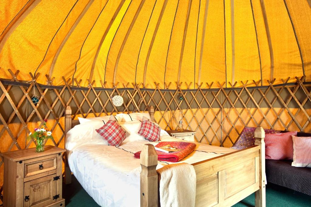 a bedroom with a bed in a yurt at Portsalon Luxury Camping in Portsalon