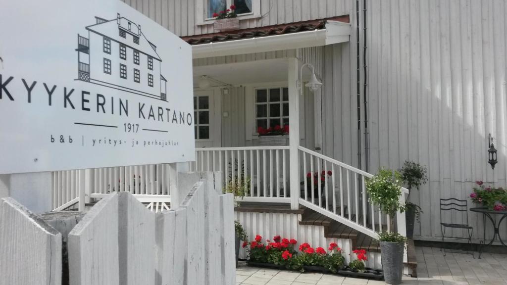 a white house with a sign on the front of it at Kyykerin Kartano in Outokumpu