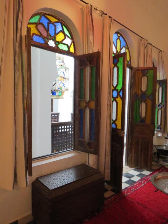 a room with a door and stained glass windows at Riad Arous Chamel in Tangier