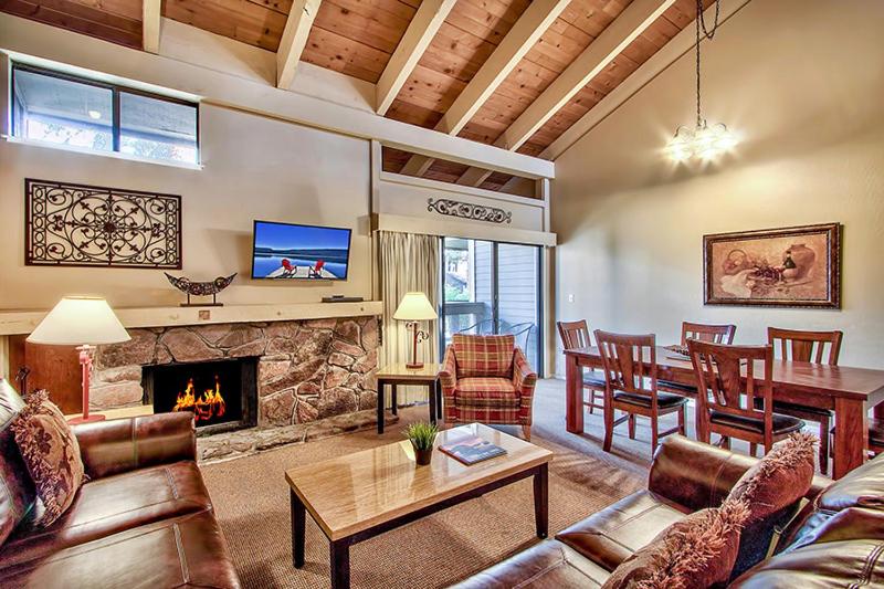a living room with a table and a fireplace at Lake Tahoe's Premier Beach, Mountain & Ski Getaway in South Lake Tahoe