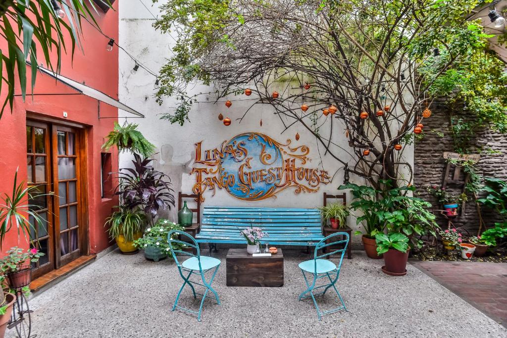 una panchina blu seduta di fronte a un edificio di Lina's Tango Guesthouse a Buenos Aires