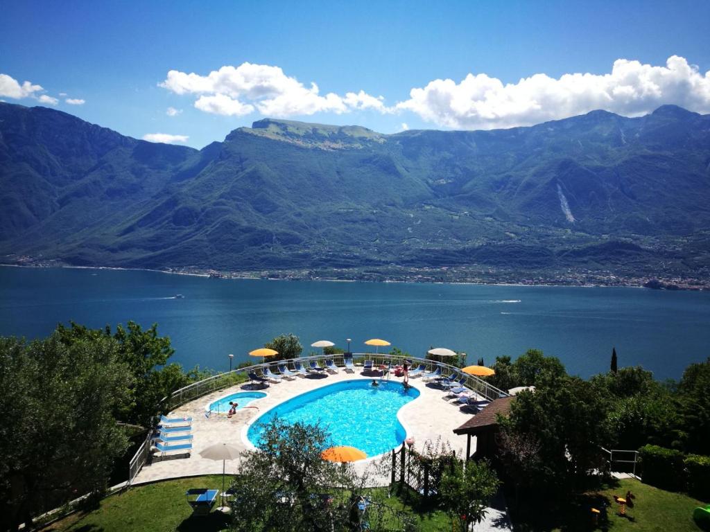 a large swimming pool with a view of a lake at Residence Hotel Maxi in Tremosine Sul Garda