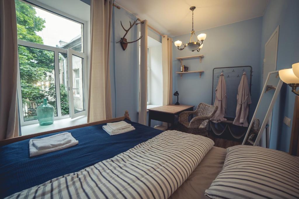 a bedroom with a bed and a window at Cuba Hostel in Saint Petersburg