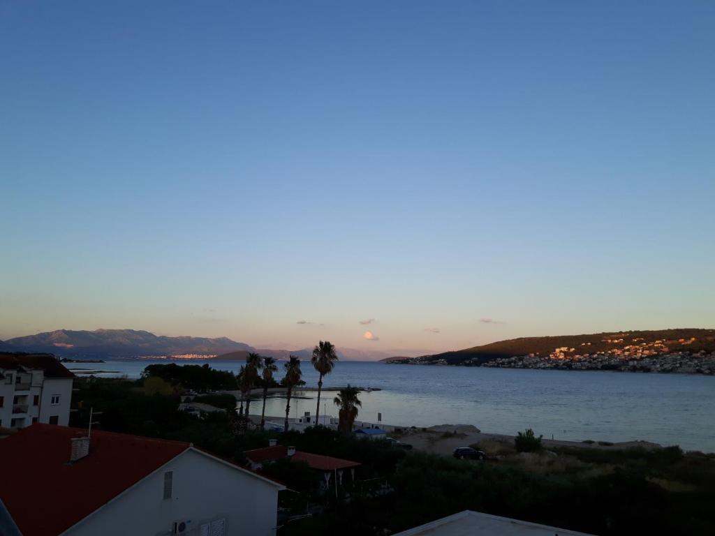 a view of the ocean at sunset at Apartments Nika in Trogir