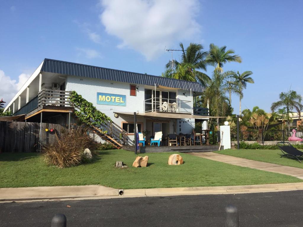 a large white building with a dog laying on top of it at Cardwell Beachfront Motel in Cardwell