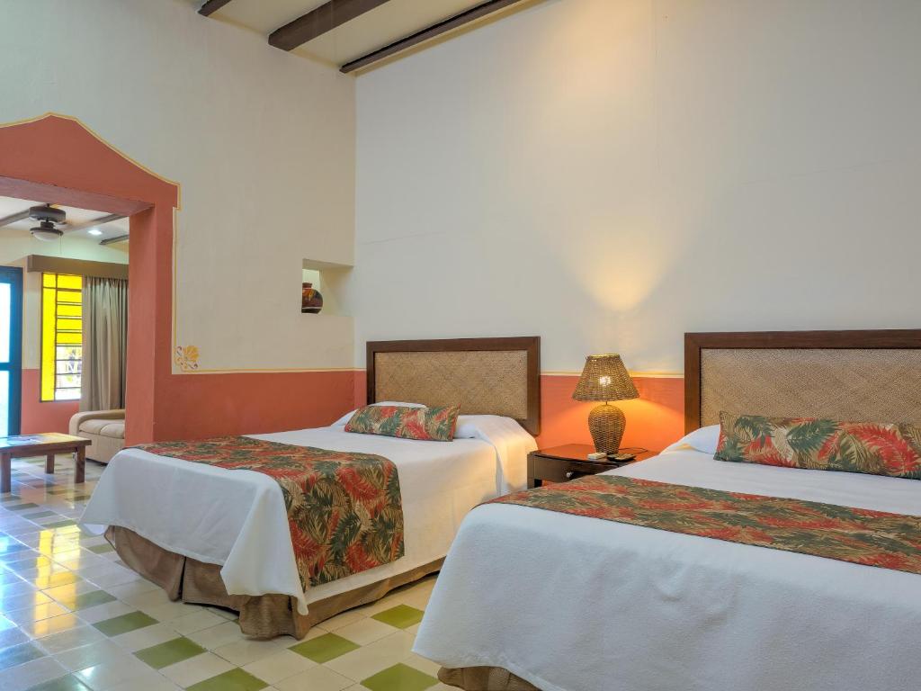 Postel nebo postele na pokoji v ubytování Hotel Luz en Yucatan
