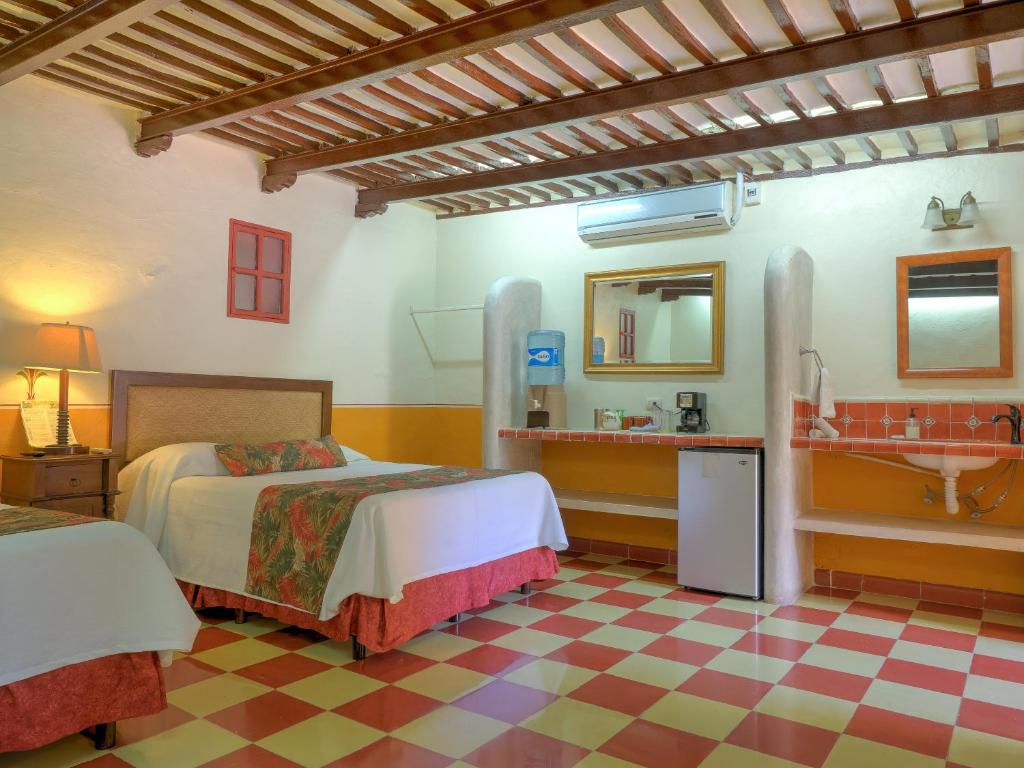 Postel nebo postele na pokoji v ubytování Hotel Luz en Yucatan