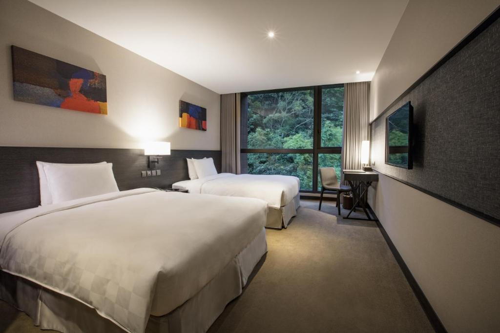 Platinum Hotel tesisinde bir odada yatak veya yataklar