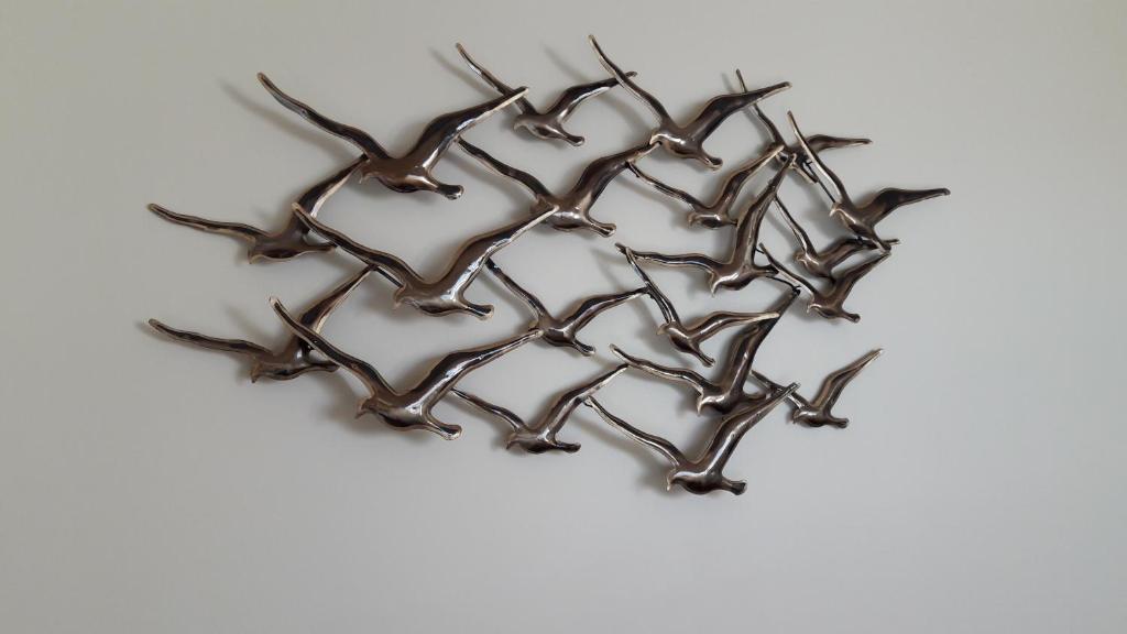 a group of birds metal wall sculpture at Aux Premières Loges in Fécamp