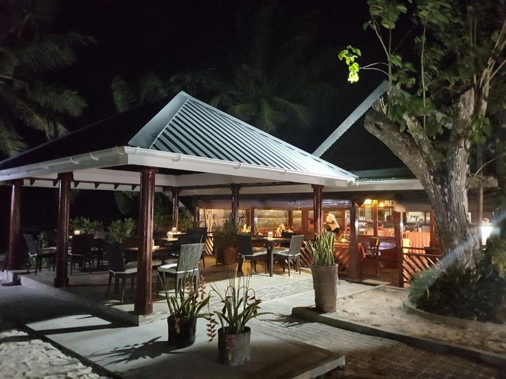 a pavilion with a solar roof at night at Villas de Mer in Grand'Anse Praslin