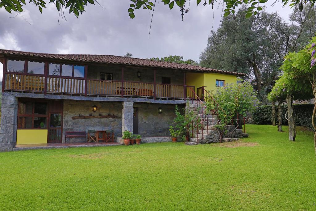 a large house with a balcony and a yard at Quinta do Galgo in Amares