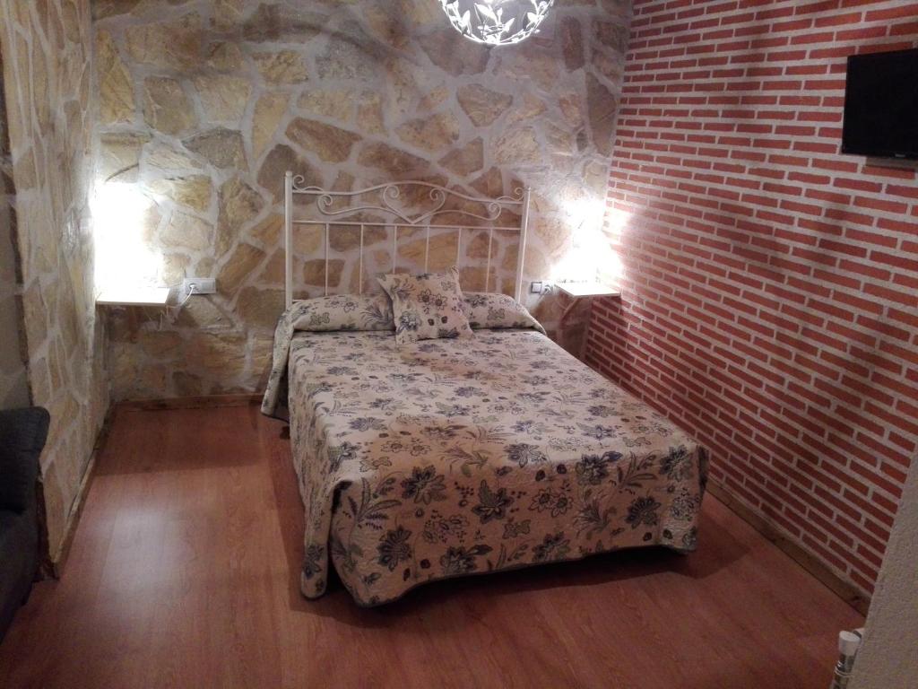 A bed or beds in a room at Abadía del Marqués de Avila