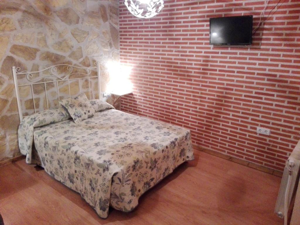 A bed or beds in a room at Abadía del Marqués de Avila